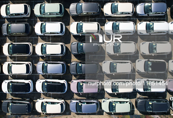 An aerial view shows various types of cars waiting to be loaded at a railway freight yard in Hangzhou, China, on December 9, 2024. 