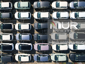 An aerial view shows various types of cars waiting to be loaded at a railway freight yard in Hangzhou, China, on December 9, 2024. (