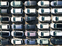 An aerial view shows various types of cars waiting to be loaded at a railway freight yard in Hangzhou, China, on December 9, 2024. (