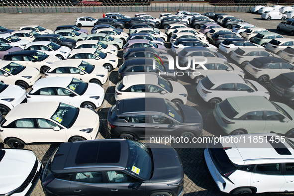 An aerial view shows various types of cars waiting to be loaded at a railway freight yard in Hangzhou, China, on December 9, 2024. 