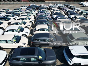 An aerial view shows various types of cars waiting to be loaded at a railway freight yard in Hangzhou, China, on December 9, 2024. (