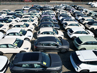 An aerial view shows various types of cars waiting to be loaded at a railway freight yard in Hangzhou, China, on December 9, 2024. (