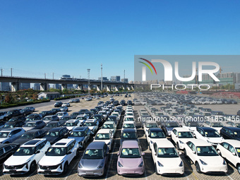 An aerial view shows various types of cars waiting to be loaded at a railway freight yard in Hangzhou, China, on December 9, 2024. (