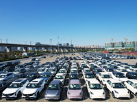 An aerial view shows various types of cars waiting to be loaded at a railway freight yard in Hangzhou, China, on December 9, 2024. (