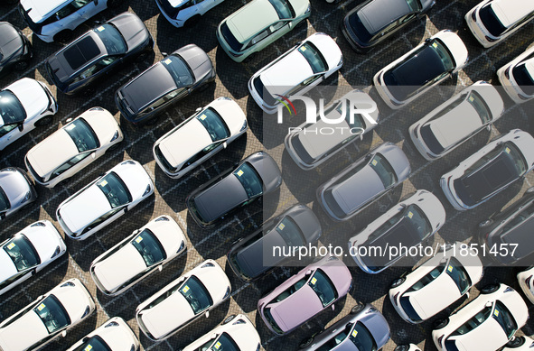 An aerial view shows various types of cars waiting to be loaded at a railway freight yard in Hangzhou, China, on December 9, 2024. 