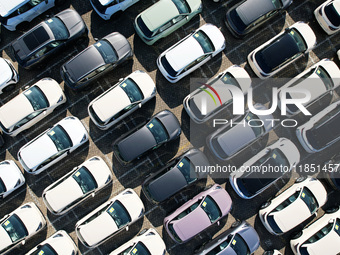 An aerial view shows various types of cars waiting to be loaded at a railway freight yard in Hangzhou, China, on December 9, 2024. (