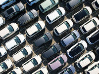 An aerial view shows various types of cars waiting to be loaded at a railway freight yard in Hangzhou, China, on December 9, 2024. (