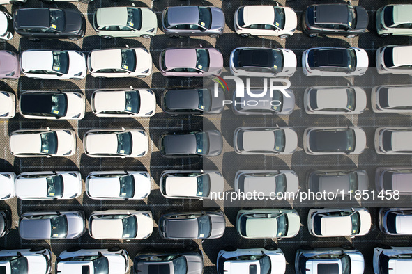 An aerial view shows various types of cars waiting to be loaded at a railway freight yard in Hangzhou, China, on December 9, 2024. 