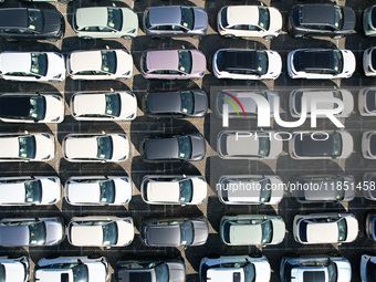 An aerial view shows various types of cars waiting to be loaded at a railway freight yard in Hangzhou, China, on December 9, 2024. (