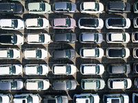 An aerial view shows various types of cars waiting to be loaded at a railway freight yard in Hangzhou, China, on December 9, 2024. (