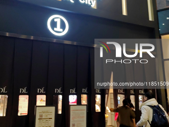 Customers enter a Pangdonglai (DL) store in Xuchang, China, on December 7, 2024. (