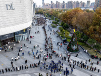 Customers line up in front of a Pangdonglai (DL) store in Xuchang, China, on December 7, 2024. (