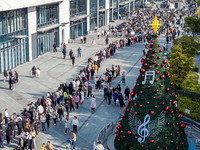 Customers line up in front of a Pangdonglai (DL) store in Xuchang, China, on December 7, 2024. (