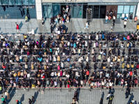 Customers line up in front of a Pangdonglai (DL) store in Xuchang, China, on December 7, 2024. (