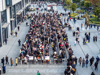 Customers line up in front of a Pangdonglai (DL) store in Xuchang, China, on December 7, 2024. (