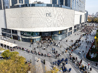 Customers line up in front of a Pangdonglai (DL) store in Xuchang, China, on December 7, 2024. (