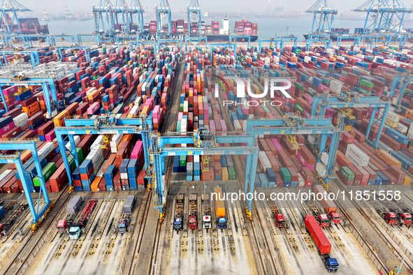 Vehicles transport foreign trade containers at a fully automated terminal in Qingdao Port in Qingdao, China, on December 10, 2024. 