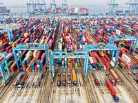 Vehicles transport foreign trade containers at a fully automated terminal in Qingdao Port in Qingdao, China, on December 10, 2024. (