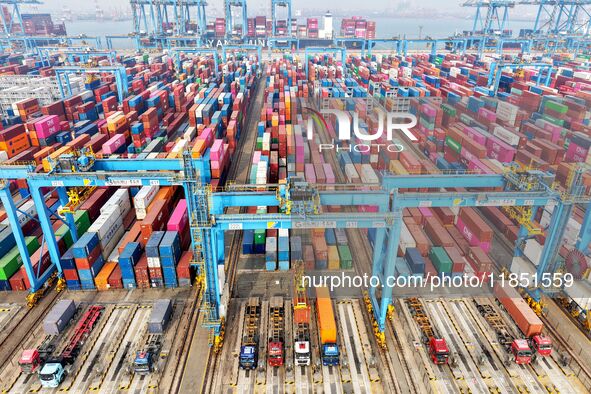 Vehicles transport foreign trade containers at a fully automated terminal in Qingdao Port in Qingdao, China, on December 10, 2024. 