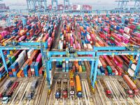 Vehicles transport foreign trade containers at a fully automated terminal in Qingdao Port in Qingdao, China, on December 10, 2024. (