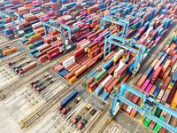 Vehicles transport foreign trade containers at a fully automated terminal in Qingdao Port in Qingdao, China, on December 10, 2024. (