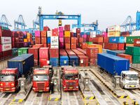 Vehicles transport foreign trade containers at a fully automated terminal in Qingdao Port in Qingdao, China, on December 10, 2024. (