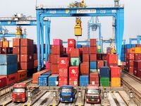 Vehicles transport foreign trade containers at a fully automated terminal in Qingdao Port in Qingdao, China, on December 10, 2024. (