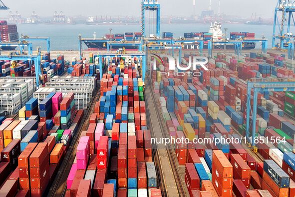 Foreign trade containers are piled up at a fully-automated terminal at Qingdao Port in Shandong province in Qingdao, China, on December 10,...