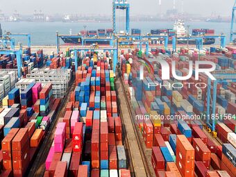 Foreign trade containers are piled up at a fully-automated terminal at Qingdao Port in Shandong province in Qingdao, China, on December 10,...