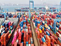 Foreign trade containers are piled up at a fully-automated terminal at Qingdao Port in Shandong province in Qingdao, China, on December 10,...