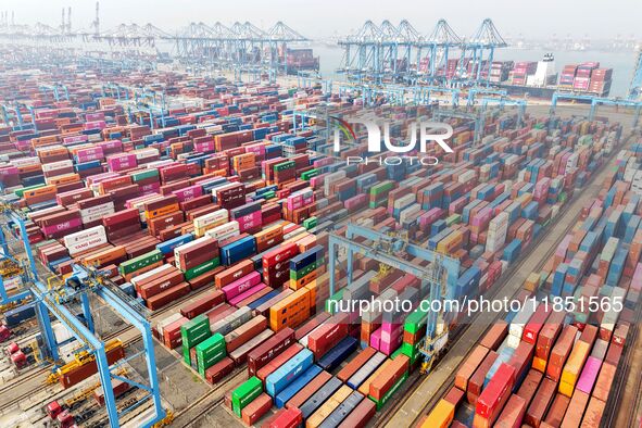 Foreign trade containers are piled up at a fully-automated terminal at Qingdao Port in Shandong province in Qingdao, China, on December 10,...