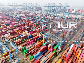 Foreign trade containers are piled up at a fully-automated terminal at Qingdao Port in Shandong province in Qingdao, China, on December 10,...