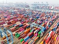 Foreign trade containers are piled up at a fully-automated terminal at Qingdao Port in Shandong province in Qingdao, China, on December 10,...