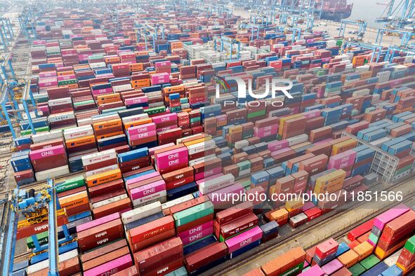 Foreign trade containers are piled up at a fully-automated terminal at Qingdao Port in Shandong province in Qingdao, China, on December 10,...