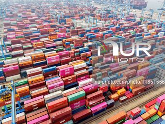 Foreign trade containers are piled up at a fully-automated terminal at Qingdao Port in Shandong province in Qingdao, China, on December 10,...