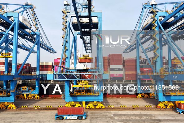 Cargo ships load and unload foreign trade containers at a fully automated terminal in Qingdao Port in Qingdao, China, on December 10, 2024. 