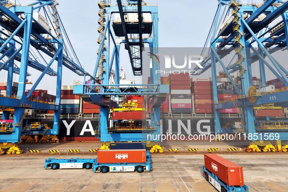 Cargo ships load and unload foreign trade containers at a fully automated terminal in Qingdao Port in Qingdao, China, on December 10, 2024. 