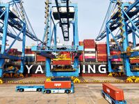 Cargo ships load and unload foreign trade containers at a fully automated terminal in Qingdao Port in Qingdao, China, on December 10, 2024....