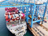 Cargo ships load and unload foreign trade containers at a fully automated terminal in Qingdao Port in Qingdao, China, on December 10, 2024....