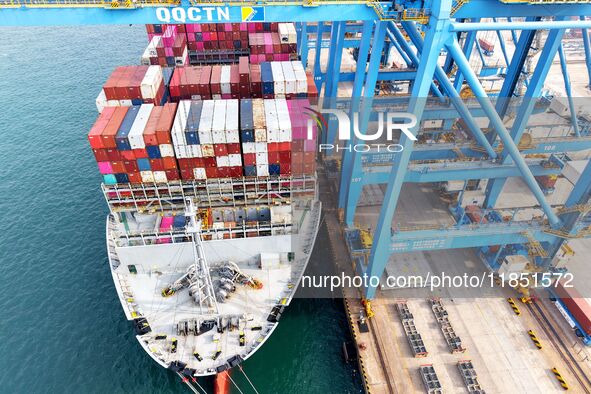 Cargo ships load and unload foreign trade containers at a fully automated terminal in Qingdao Port in Qingdao, China, on December 10, 2024. 