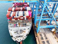 Cargo ships load and unload foreign trade containers at a fully automated terminal in Qingdao Port in Qingdao, China, on December 10, 2024....