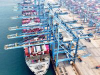 Cargo ships load and unload foreign trade containers at a fully automated terminal in Qingdao Port in Qingdao, China, on December 10, 2024....