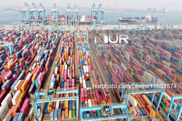 Cargo ships load and unload foreign trade containers at a fully automated terminal in Qingdao Port in Qingdao, China, on December 10, 2024. 