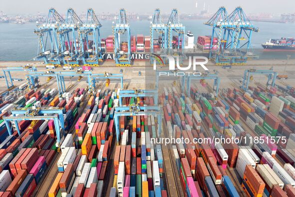 Cargo ships load and unload foreign trade containers at a fully automated terminal in Qingdao Port in Qingdao, China, on December 10, 2024. 