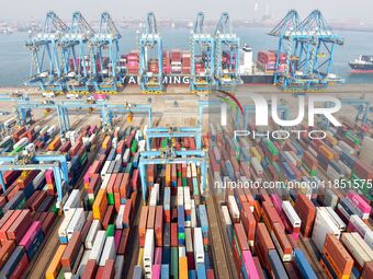 Cargo ships load and unload foreign trade containers at a fully automated terminal in Qingdao Port in Qingdao, China, on December 10, 2024....