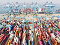 Cargo ships load and unload foreign trade containers at a fully automated terminal in Qingdao Port in Qingdao, China, on December 10, 2024....