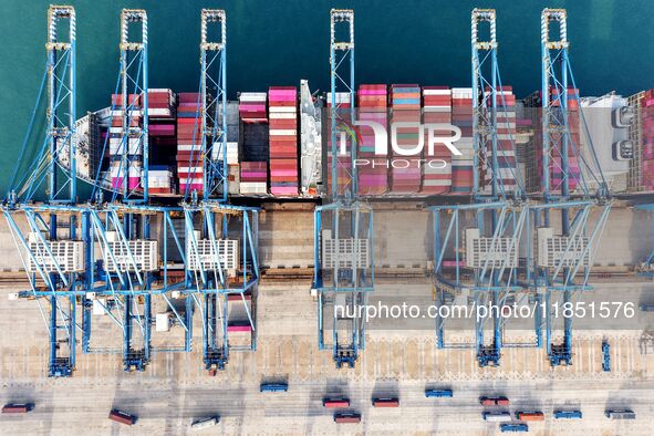 Cargo ships load and unload foreign trade containers at a fully automated terminal in Qingdao Port in Qingdao, China, on December 10, 2024. 