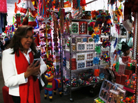 A woman walks past a stand where various items are sold for the Christmas season in the Tlalpan Center in Mexico City, Mexico, on December 7...