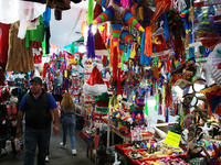 A man walks through a market where various items are sold for the Christmas season and the posadas, installed in the Tlalpan Center in Mexic...