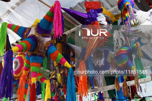 Different pinatas are seen at a tianguis, where various items are sold for the Christmas season and the posadas, in the Tlalpan Center in Me...